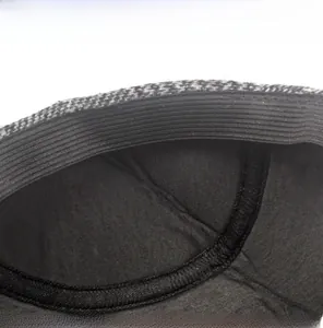 Detail view of the adjustable elastic strap inside the grey plaid wool newsboy cap
