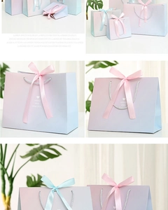 Detail of gradient pink and blue gift bags with silk ribbon handles and heart print