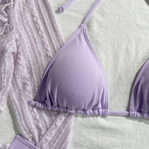 Detailed flat lay of lavender ribbed bikini with delicate lace cover-up set