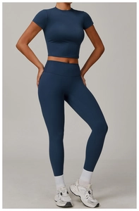 Front view of women's dark blue brushed yoga set with high waist leggings and crop top