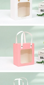 Detail of premium paper gift bag with transparent window and white ribbon handles