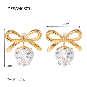 Macro shot of gold bow heart earrings with zircon studs showing 2cm height and 6.1g weight
