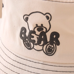 Beige cotton bucket hat for kids with cartoon bear embroidery and black stitching