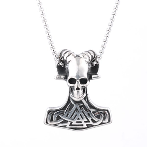 Macro view of vintage silver Viking Mjölnir pendant with skull and ram horn engravings