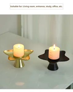 Star-shaped metal candle tray with hammered texture and white pillar candle detail
