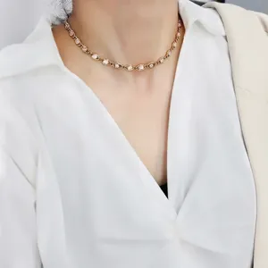 Elegant 18K gold plated choker necklace featuring pink round cubic zirconia stones on a model