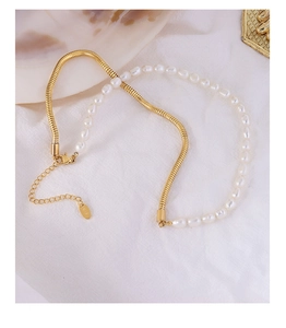 Detail of 18K gold plated chain necklace with freshwater pearls and lobster clasp closure