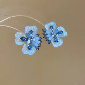 Blue crystal flower stud earrings with resin petals and pearls for a fresh summer look