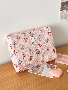 Pink quilted makeup bag with vintage cartoon bear and rabbit prints for vanity storage