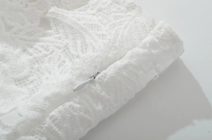 Detail of white lace texture and invisible zipper on the high-quality fashion garment