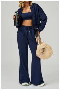 Three-piece navy blue sportswear set with zip-up hoodie, sports bra, and wide-leg sweatpants