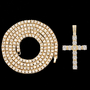 Macro detail of golden hip hop tennis chain and sparkling zircon encrusted cross pendant