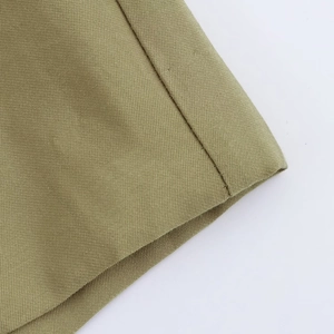 Macro shot of khaki cotton fabric texture and precise stitching on casual shorts