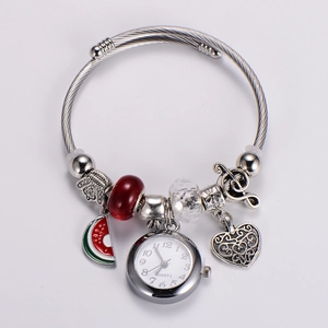 Macro shot of silver quartz watch bracelet with red watermelon and heart charms