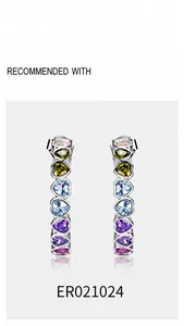 Detailed view of silver hoop earrings featuring multi-color heart-cut rainbow zircons