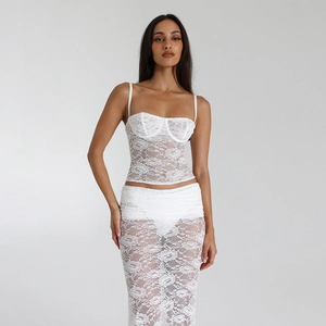 Detail of white lace camisole top and sheer skirt with intricate floral patterns