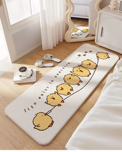 Detail of plush cream bedroom rug featuring yellow cartoon chicks on light wood flooring