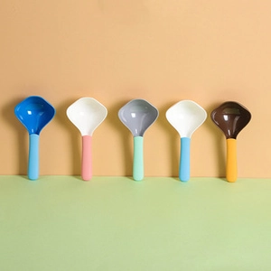 Close-up of colorful plastic measuring spoons in blue, pink, green, and yellow tones