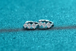 Macro shot of 925 silver hoop earrings with three sparkling round moissanite stones