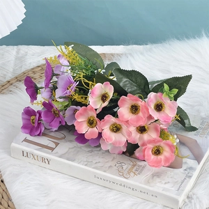 Lifelike silk cherry blossom bouquet with pink and purple daisies on a luxury wedding book