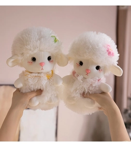 Close-up of fluffy white lamb plush toys with lace bows and cute flower decorations
