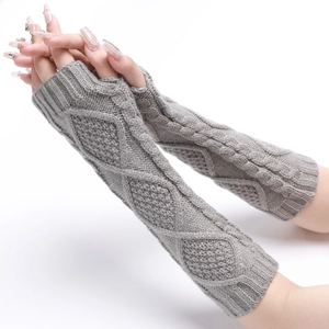 Macro shot of grey diamond cable knit texture on fingerless arm warmer gloves