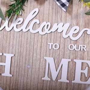 Round wooden welcome sign for home decor with white 3D lettering and natural wood grain