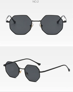 Detail view of black polygonal sunglasses with sleek metal frame and dark UV lenses