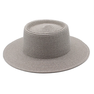 Detail of grey wide brim straw boater hat showing fine spiral weaving texture
