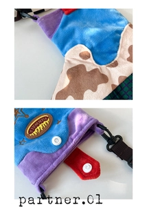 Close-up of colorful plush patchwork bag with Vanwalk logo and cow print texture