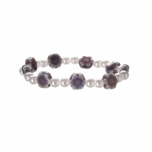 Detail of beaded bracelet with white imitation pearls and purple ceramic flower charms