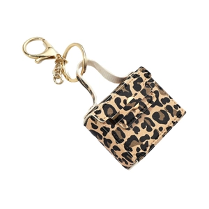 Mini leopard print handbag keychain with golden metal ring and chain on white background