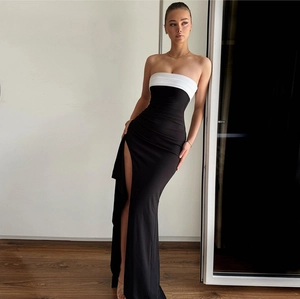 Detail of black and white off-shoulder slit dress with elegant chest color blocking