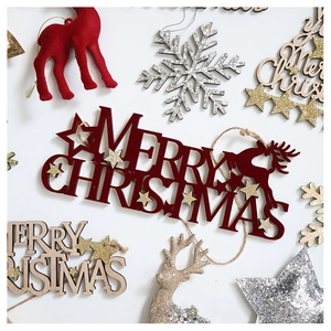 Flat lay of red flocked and gold star wooden Merry Christmas ornaments for trees