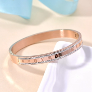 Detail of rose gold bangle with roman numerals and double rows of sparkling crystals