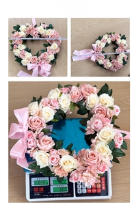 Detail view of heart-shaped rose wreath dimensions and weight measurement on scale