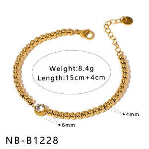 Gold stainless steel beaded bracelet featuring a sparkling zircon crystal centerpiece