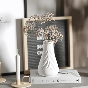 White ceramic leaf embossed vase with matte texture for minimalist home interior decor
