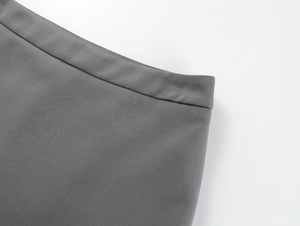 Detail of the high-quality gray woven fabric and waist stitching on the A-line skirt