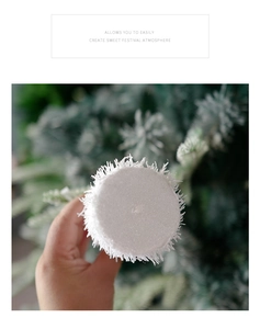 Detail of white snowy Christmas foam ball with glitter texture and plush finish