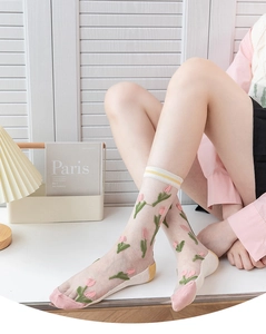Detail view of sheer white mesh socks with pink tulip embroidery and striped cuffs