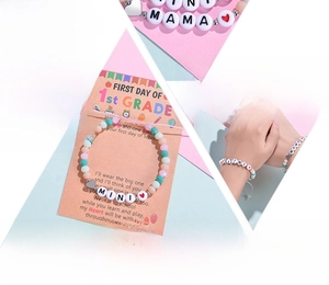 Detail of colorful crystal bead bracelet set with MAMA and MINI letter beads on pink card