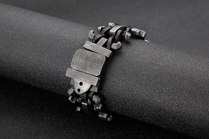 Close-up of industrial style stainless steel bracelet with gear and mechanical chain details