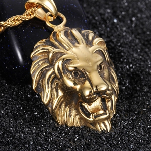 Vintage golden lion head pendant necklace with twisted rope chain on black sand background