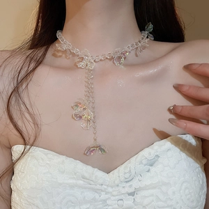 Detailed shot of iridescent butterfly charms and transparent beads on a layered necklace