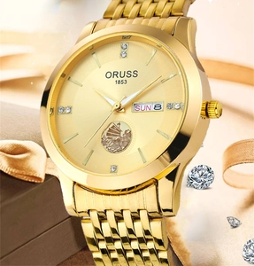 Detailed macro view of the ORUSS gold men's watch featuring a sailing boat emblem