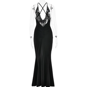 Detail of the slim fit black backless evening dress with cross straps and fishtail hem