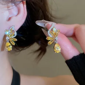 Elegant silver butterfly earrings with sparkling yellow zircons and marquise accents