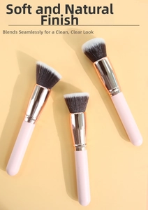 Detailed close-up of three pink foundation brushes with slanted and flat heads