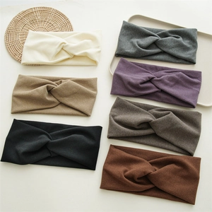 Flat lay of seven knit headbands in various neutral colors on a minimal background